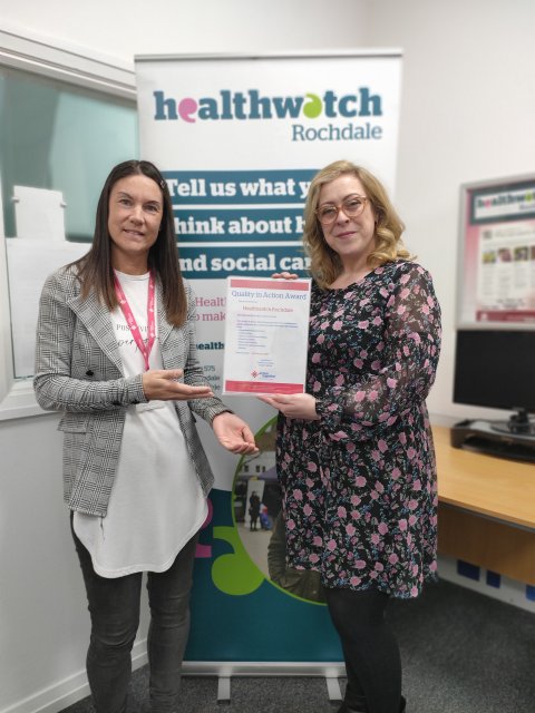 Action Together employee handing Healthwatch Rochdale their Quality in Action Award