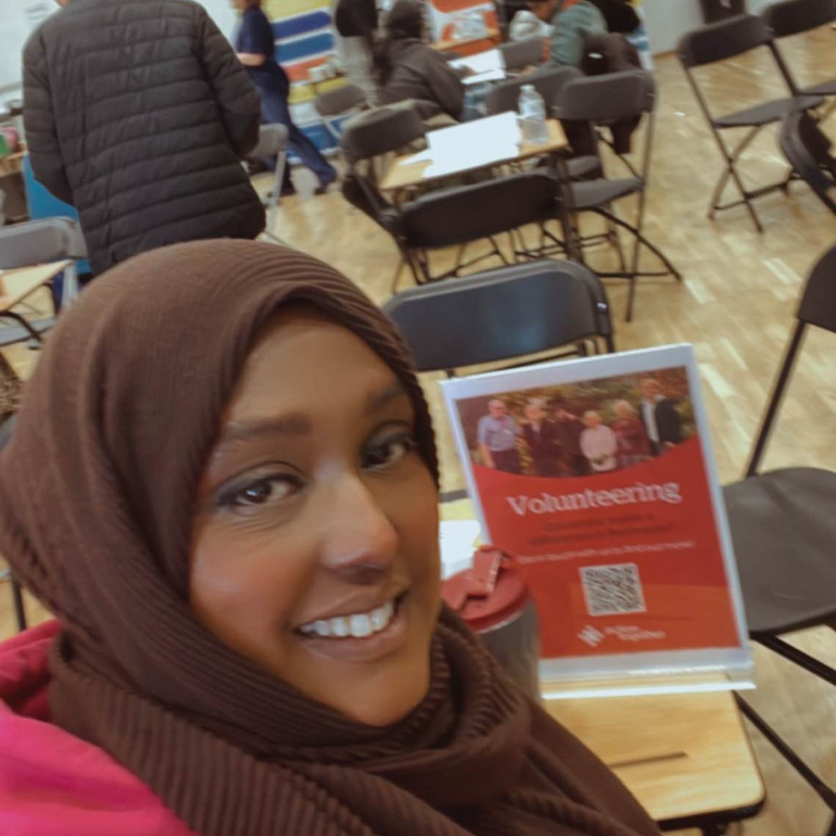 Asma sat at desk at Edgar Wood Academy careers event