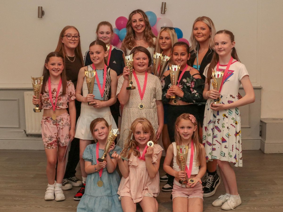Girls holding trophies