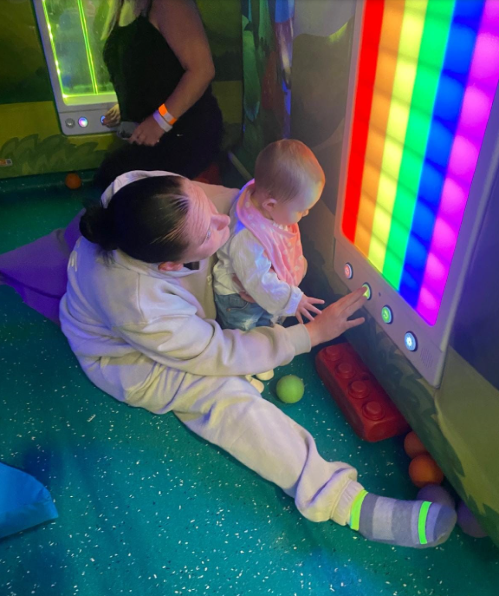 Woman and baby playing with lights