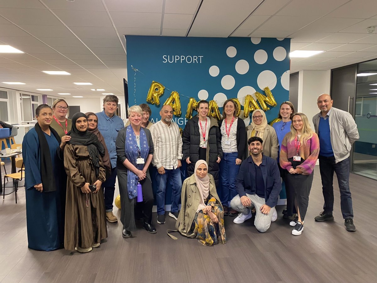 Group of people stood in front of blue wall