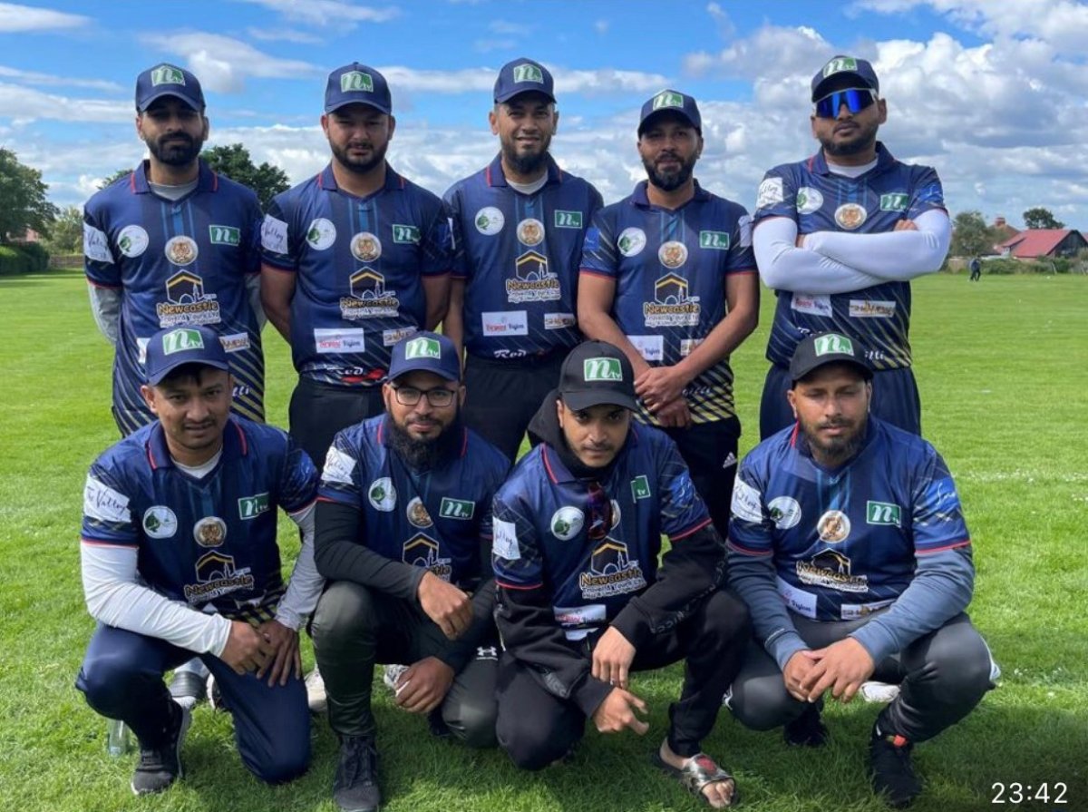 Men in cricket uniform in a field