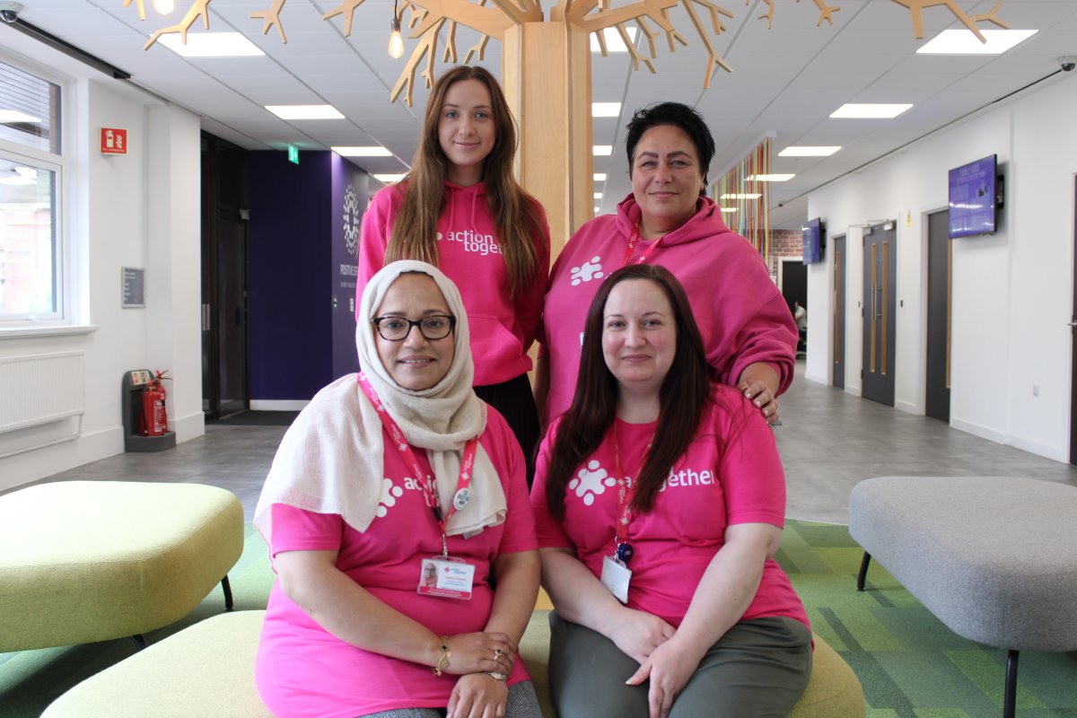 Group of women in pink tshirts smiling