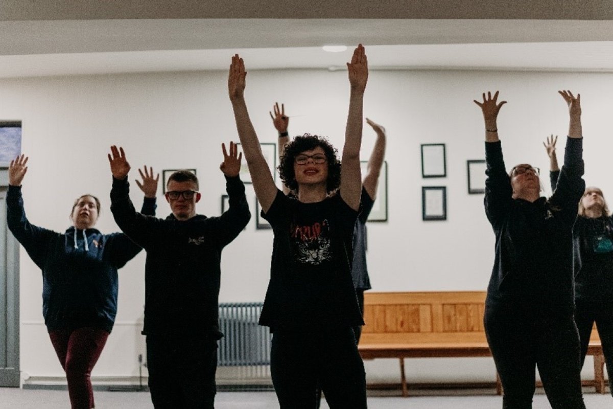 Group of people with their hands raised