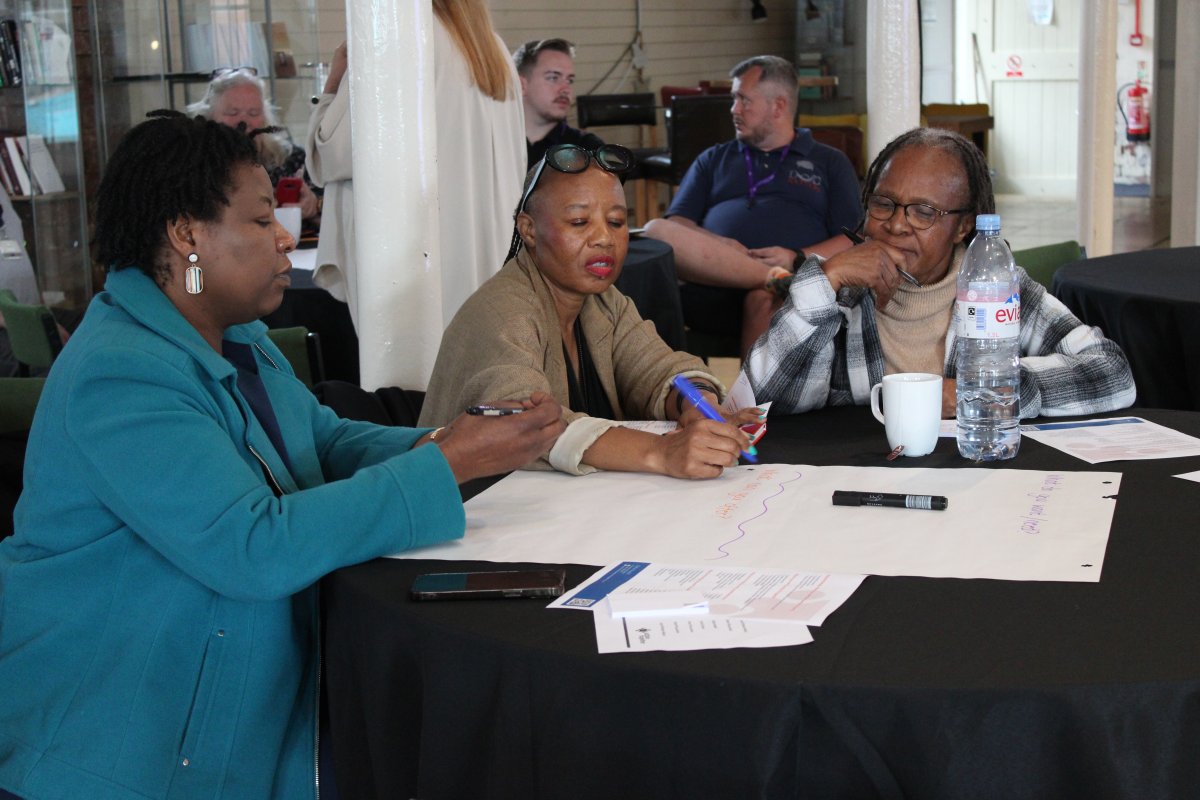 Women sat at a table making notes