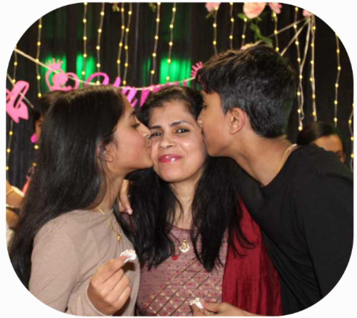 Kids kissing mother on cheeks