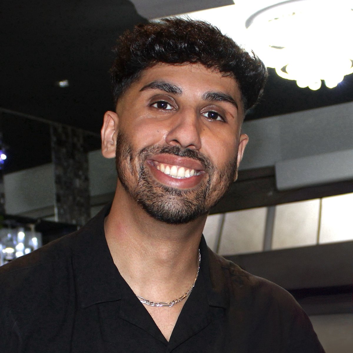 Photo of Kasim Bukhari smiling at camera