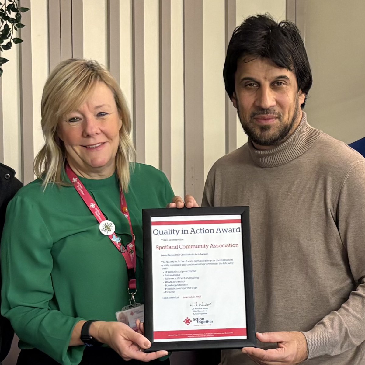 Photo of Julie Durrant with Asghar Ali from Spotland Community Centre receiving a Quality in Action Award