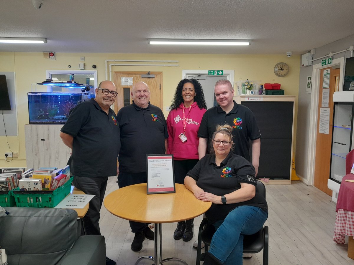 Neon team receiving the QiAA