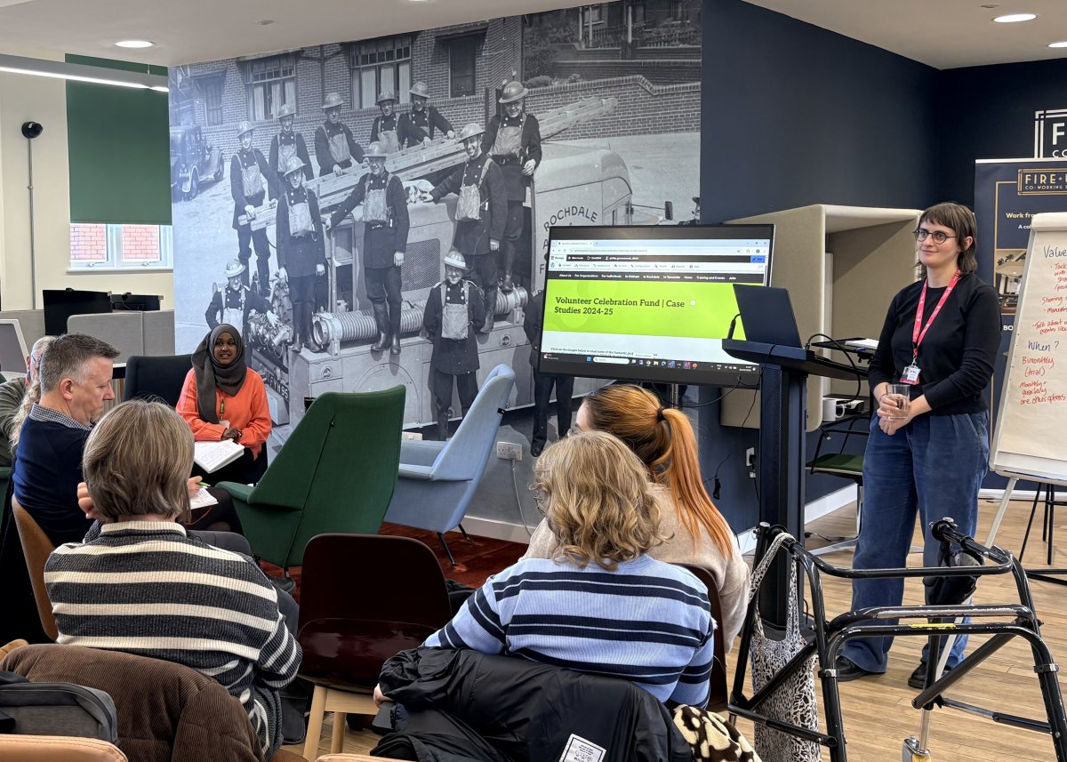 Volunteer Support Officer Sandy Rushton presenting to a group of people seated