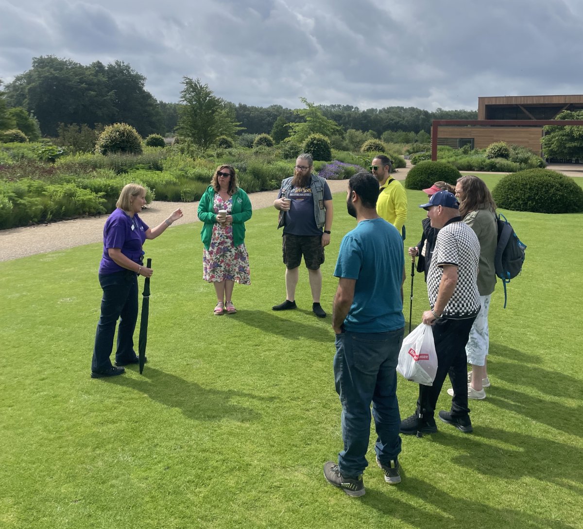 People standing in a garden having a tour