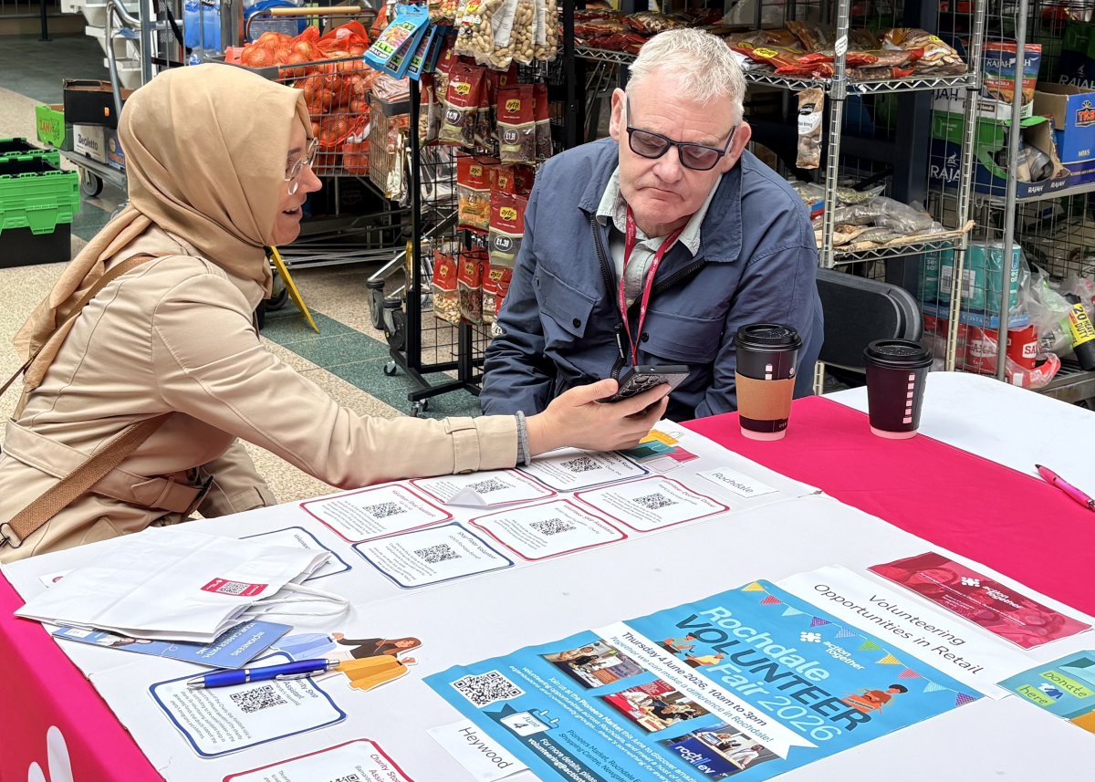 Phil Greenwood supporting volunteer at stall